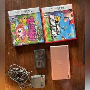Nintendo DS lite with 4 games and a charger and game case